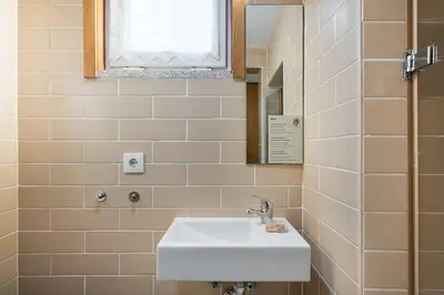 a bathroom with a sink and a mirror at GuestReady - Invicta Porto Guest House in Porto