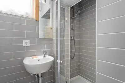 a bathroom with a sink and a shower at GuestReady - Invicta Porto Guest House in Porto