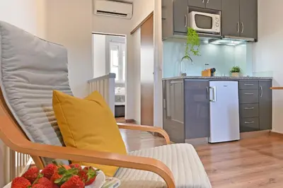a kitchen with a chair and a bowl of strawberries at Casa do Palácio 16 e 17 in Porto