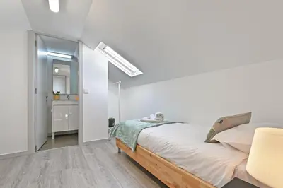 a white bedroom with a bed and a mirror at Crystal Palace House - D19 in Porto
