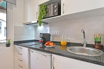 a kitchen with a sink and a bowl of fruit on a counter at Crystal Palace House - D19 in Porto