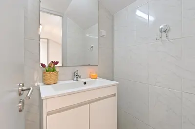 a white bathroom with a sink and a mirror at Crystal Palace House - D19 in Porto