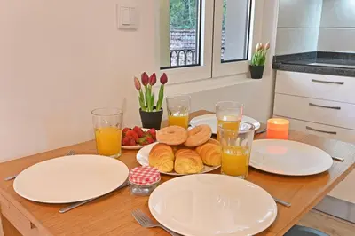 a table with plates of food and glasses of orange juice at Crystal Palace House - D19 in Porto