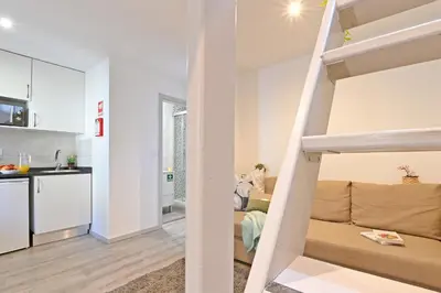 a small apartment with a loft bed and a kitchen at Crystal Palace House - D19 in Porto