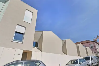 a building with cars parked in front of it at Vera Cruz Porto Apartment in Porto