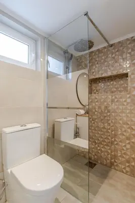a bathroom with a toilet and a glass shower at Quinta do Vintém near WOW by HostWise in Vila Nova de Gaia