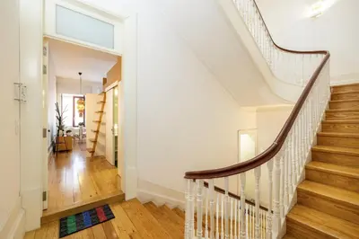 a staircase in a home with white walls and wood floors at Porto Ribeira Flat in Porto