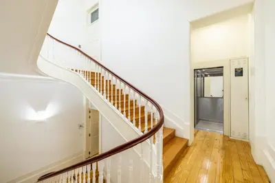 a staircase in a home with white walls and wood floors at Porto Ribeira Flat in Porto
