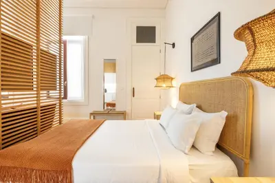 a bedroom with a bed and a window at Porto Ribeira Flat in Porto
