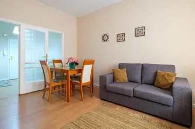a living room with a couch and a table at Spacious 3 BRs Apartment, steps to Joao's station in Vila Nova de Gaia