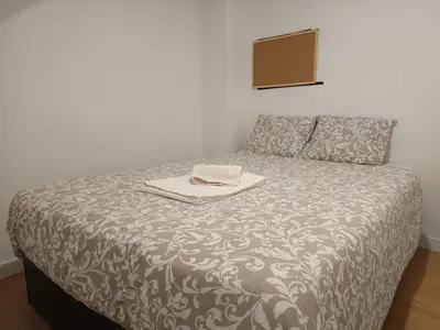 a bed in a room with a blanket on it at Original Porto - Cedofeita in Porto