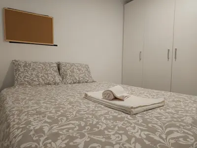 a bed with a towel and a hat on it at Original Porto - Cedofeita in Porto