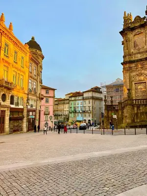 a city square with buildings and people walking around at The Arcada House by MyMoradia in Porto