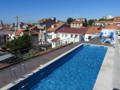 a swimming pool on the roof of a house at Porto Náutico & Spa in Porto
