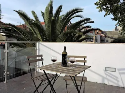 a table with two glasses of wine on a balcony at Porto Náutico & Spa in Porto