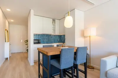 a kitchen and dining room with a table and chairs at HostWise - Modern Flat in Boavista in Porto