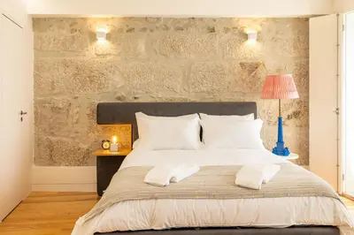a bedroom with a large bed with two white pillows at Central charming flat SÉ by casaporto207 in Porto