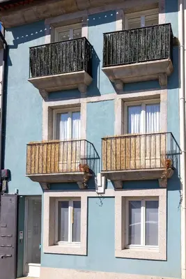 a blue building with balconies on the side of it at Central charming flat SÉ by casaporto207 in Porto