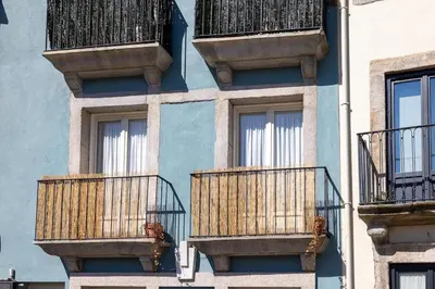 a blue building with balconies on the side of it at Central charming flat SÉ by casaporto207 in Porto