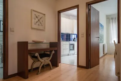 a kitchen with a table and a chair in a room at Aposentus - Cest La Vie in Porto