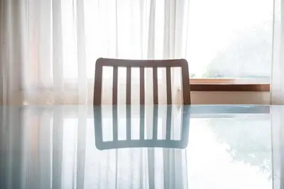 a chair sitting at a glass table in front of a window at Aposentus - Cest La Vie in Porto
