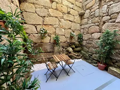 a bedroom with a large bed with white sheets at Cais das Flores in Vila Nova de Gaia
