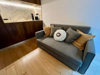 a bedroom with a large white bed with a wooden wall at Cais das Flores in Vila Nova de Gaia