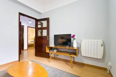 a living room with a television on a table at APOSENTUS - Serenity 2E in Porto