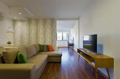 a living room with a couch and a table at APOSENTUS - The First in Porto
