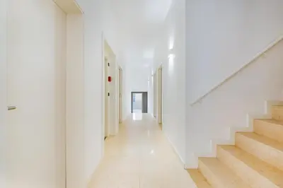 a hallway of a house with white walls and stairs at GuestReady - A lovely stay in Rua da Boavista in Porto