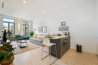 a kitchen and living room with a couch and a table at GuestReady - A lovely stay in Rua da Boavista in Porto