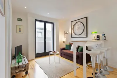 a living room with a couch and a table at APOSENTUS - Porto's Charming Apartment in Porto