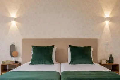 a bedroom with two beds with green pillows at Porto Luxury II in Porto