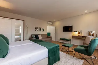 a bedroom with a large bed and a living room at Porto Luxury II in Porto