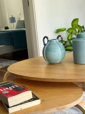 a table with a blue vase sitting on top of it at Apartamento Ponte D Luís in Vila Nova de Gaia