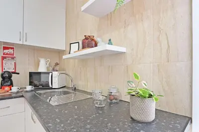 a kitchen counter with a sink and a microwave at Apartamento Ponte D Luís in Vila Nova de Gaia