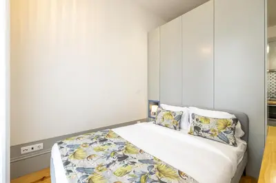 a bedroom with a bed with white walls and pillows at 741 Studio By D&S in Porto