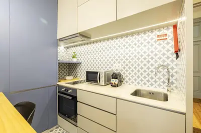 a kitchen with a sink and a microwave at 741 Studio By D&S in Porto