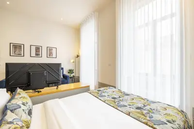 a bedroom with a bed and a flat screen tv at 741 Studio By D&S in Porto