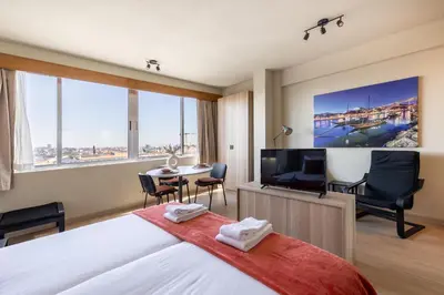 a hotel room with a bed and a flat screen tv at Skyline Porto Apartment - Porto Velho Apt in Porto