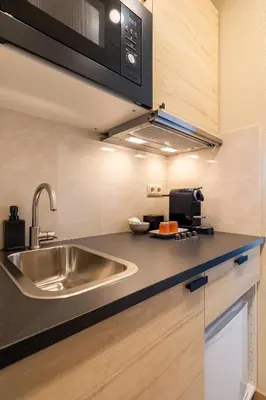 a kitchen with a sink and a microwave at Skyline Porto Apartment - Porto Velho Apt in Porto