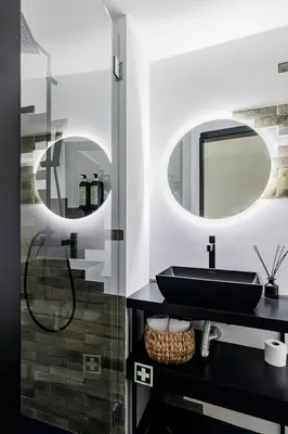 a bathroom with a black sink and two mirrors at Regras Apartments & Garden by Benefit Collection B in Porto