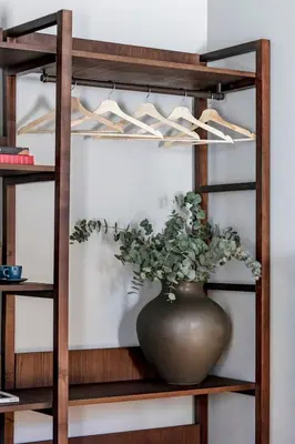 a vase sitting on a shelf with a plant in it at Regras Apartments & Garden by Benefit Collection B in Porto