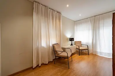 a room with two chairs and a desk and a window at O'Porto Main Street St Catarina 1 in Porto