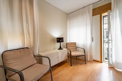 a room with two chairs and a desk and a lamp at O'Porto Main Street St Catarina 1 in Porto