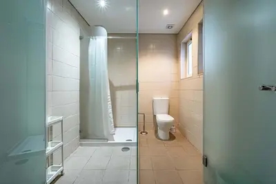 a bathroom with a toilet and a glass shower at O'Porto Main Street St Catarina 1 in Porto