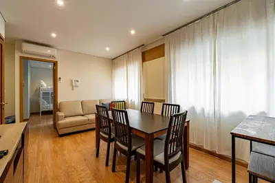 a dining room with a table and chairs and a couch at O'Porto Main Street St Catarina 1 in Porto