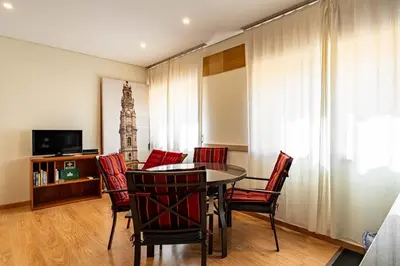 a dining room with a table and red chairs at O'Porto Main Street St Catarina 2 DOWNTOWN in Porto