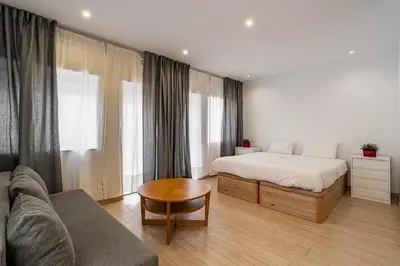 a bedroom with a bed and a couch at O'Porto Main street St Catarina 3 Rooftop in Porto