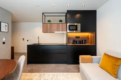 a living room with a couch and a kitchen at DoisPontoZero Fonseca Cardoso in Porto